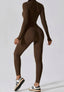 The model wearing Mojave Long Sleeved Jumpsuit slimming shaper tight lifting jumpsuit romper leggings bodysuit yoga outfit set