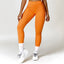 The model wearing orange Malibu Sport Leggings High Waist - NUFIT STORE slimming shaper tight lifting jumpsuit romper leggings bodysuit yoga outfit set