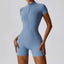 The model wearing Haze Blue Mojave Short Sleeve Romper slimming shaper tight lifting jumpsuit romper leggings bodysuit yoga outfit set