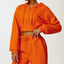 The model wearing orange Malibu Long-sleeved Sweater orange prisoner prison - NUFIT STORE front view slimming shaper tight lifting jumpsuit romper leggings bodysuit yoga outfit set