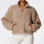 The model wearing Khaki Brown Activewear Berber Short Jacket with Handwarmer Pockets, no hood, no bottom hem, no ribbed cuffs slimming shaper tight lifting jumpsuit romper leggings bodysuit yoga outfit set