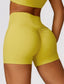 The model wearing Curry yellow Morocco shorts - NUFIT STORE slimming shaper tight lifting jumpsuit romper leggings bodysuit yoga outfit set